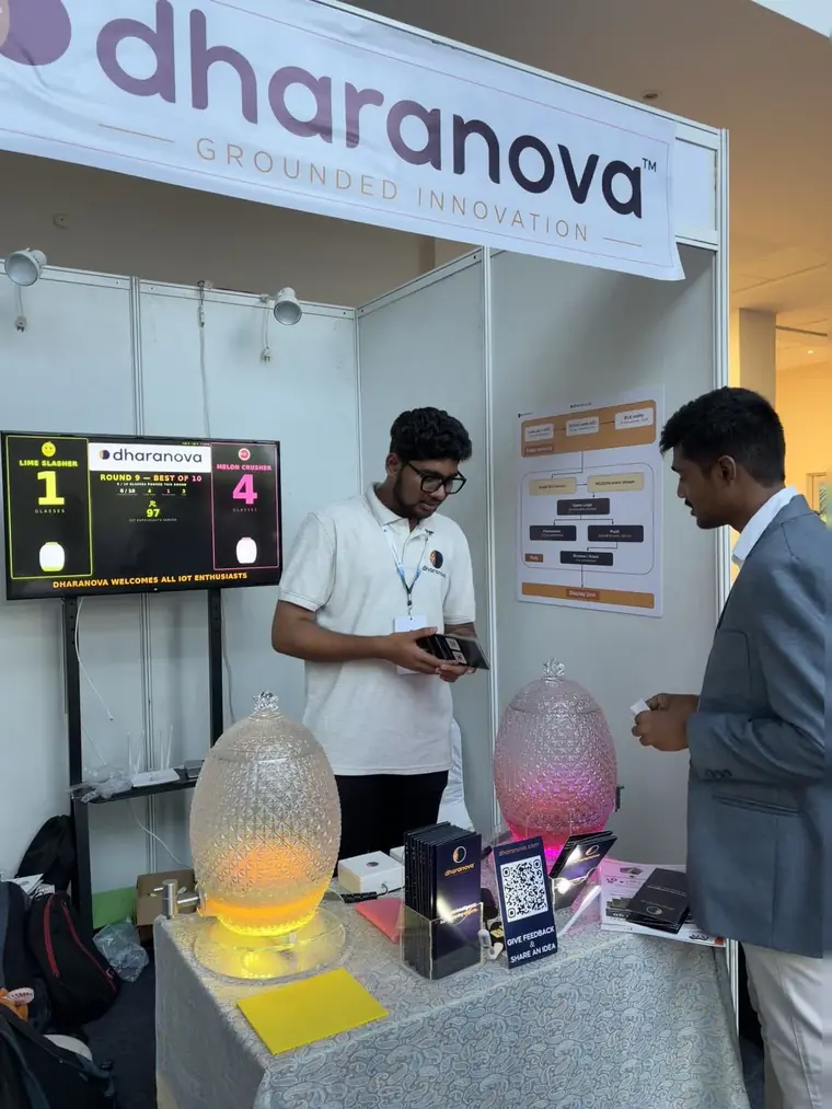 Ritesh Bonthalakoti at the booth beside the scoreboard and the printed flow diagram showing sensor reading, Bluetooth notify, event stream, game logic, persistence and display.