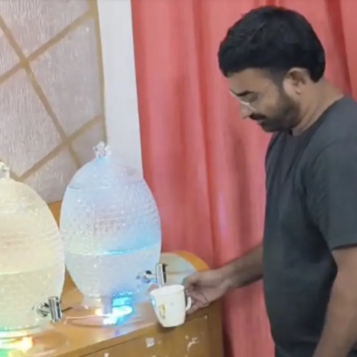 Nanupatruni Mahesh Kumar pouring from one of the jars into a cup during a test.
