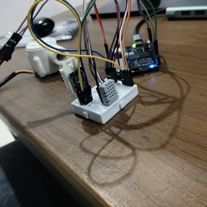A breadboard carrying the DHT22 and AGS02MA sensors, wired with jumper leads.